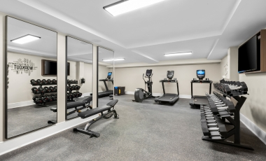 A well-equipped gym with mirrors, available in a hotel near the FIFA World Cup in New Jersey.