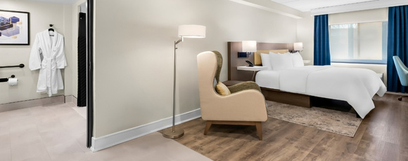 Hotel room with bed, chair, desk near FIFA World Cup NJ.