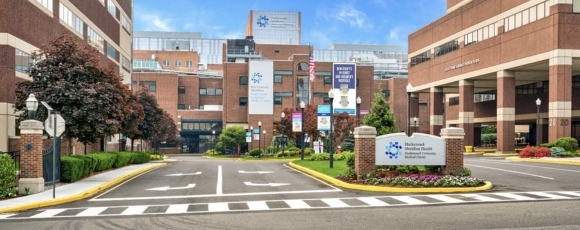 Hotel-Near-Hackensack-University-Medical-Center-NJ-Hackensack-Medical-Center-1 Entrance of a hospital with a prominent sign, located at Hackensack University Medical Center, NJ.