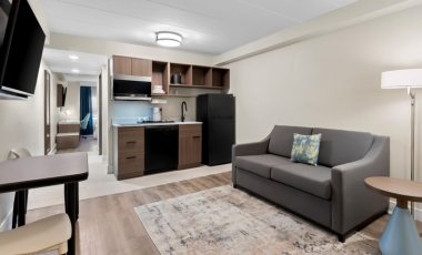 Studio suite with kitchenette, seating, workspace at Latitude Suites.