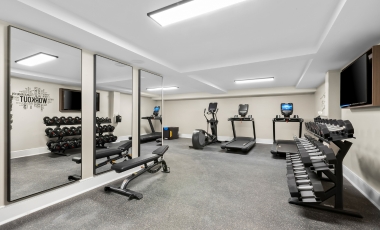 Fitness area with mirrors and exercise equipment, situated in a hotel near MetLife Stadium.