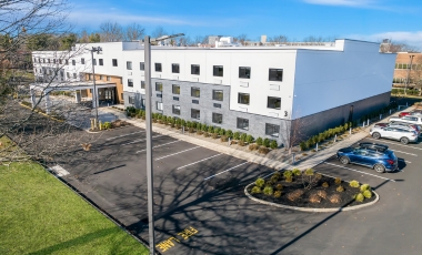 Latitude Suites exterior with parking near MetLife Stadium.