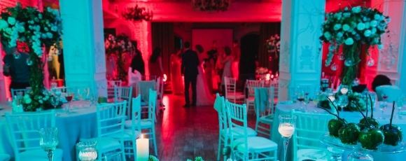 A beautifully decorated wedding reception space featuring red lighting, creating a romantic ambiance at Hotel Near Shark River Park.