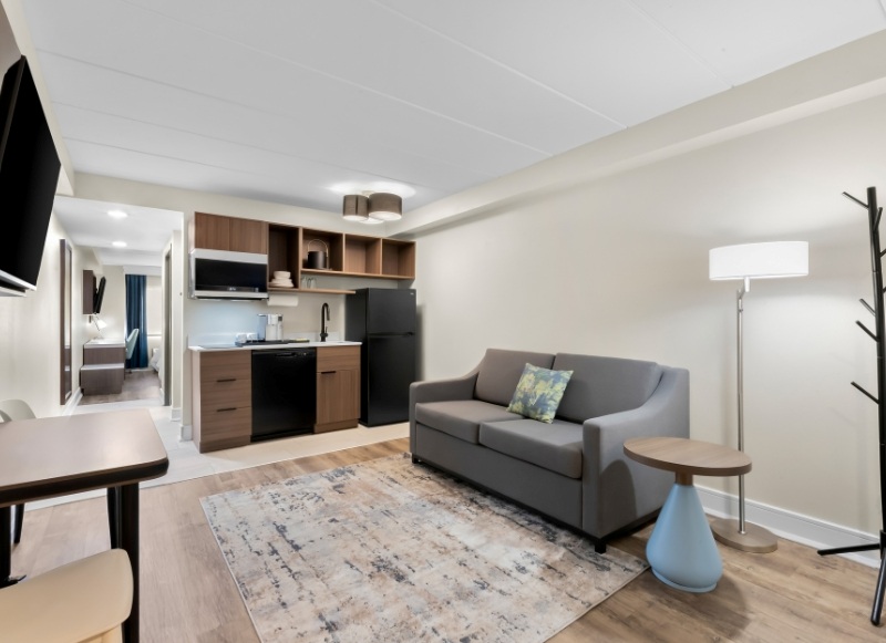 Hotel-near-Gateway-National-Recreation-Area-1 A cozy hotel living room featuring a couch, table, and television, located near Gateway National Recreation Area.