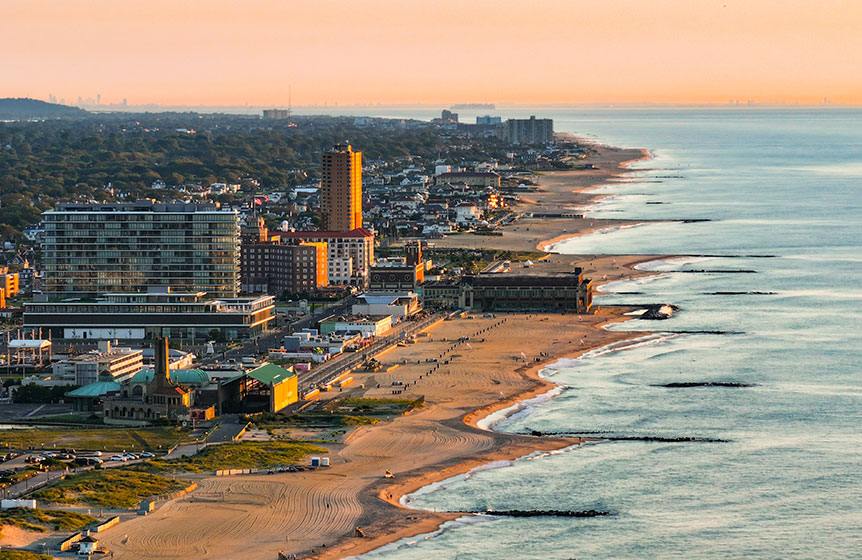 This scenic aerial captures Asbury Park’s iconic beachfront, where golden sands meet the Atlantic Ocean, highlighting the city’s vibrant coastal charm and relaxed seaside atmosphere.