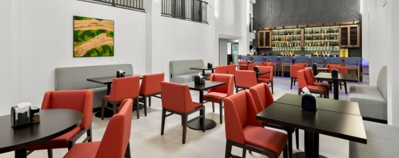 Hotel-Near-Paramount-Theatre-Asbury-Park-Social-Centre-Bistro-2 Restaurant interior with red chairs near Paramount Theatre.