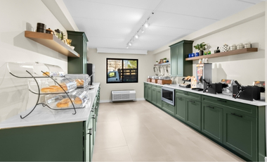 Hotel breakfast area with hot food station and fresh options at Latitude Suites