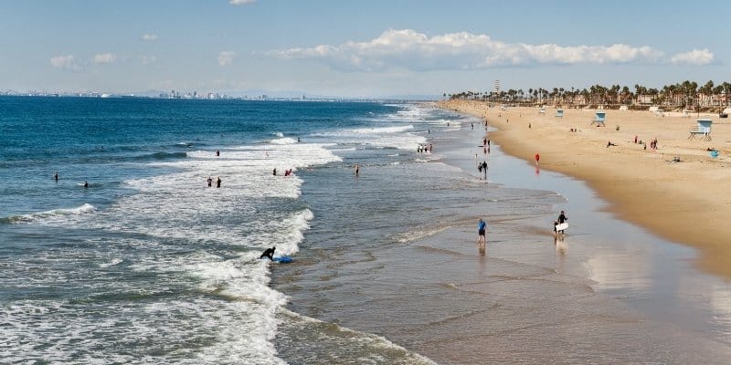 Waves rolling onto the Jersey Shore as visitors enjoy a sunny beach day and ocean views