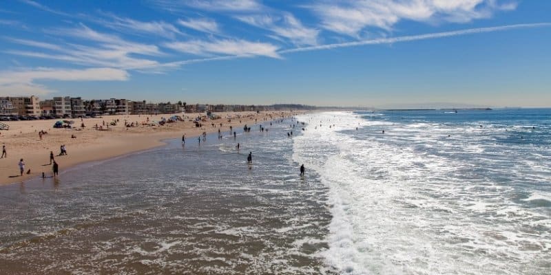 Sunny New Jersey beach shoreline with gentle waves and warm August weather
