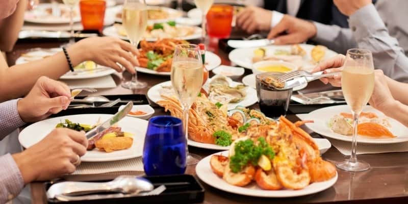A group of people enjoying fresh seafood dining in Cape May during a Jersey Shore fall getaway
