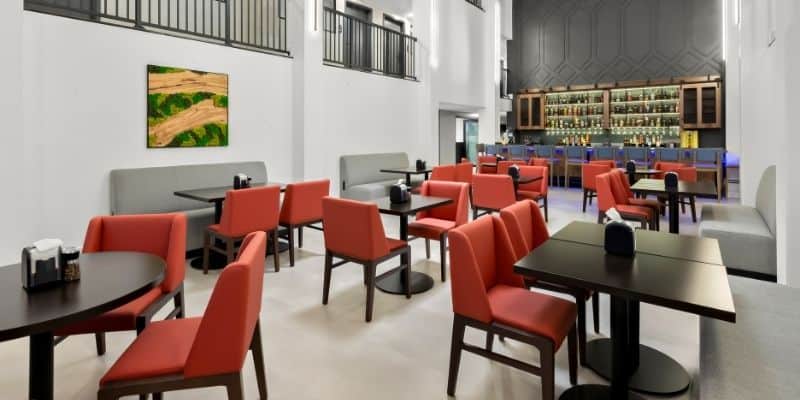 On-site dining area at Latitude Suites near Tinton Falls with tables and bar seating